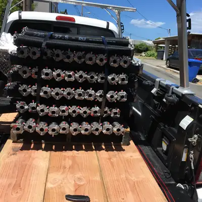 Stack of new torsion springs strapped in a truck bed