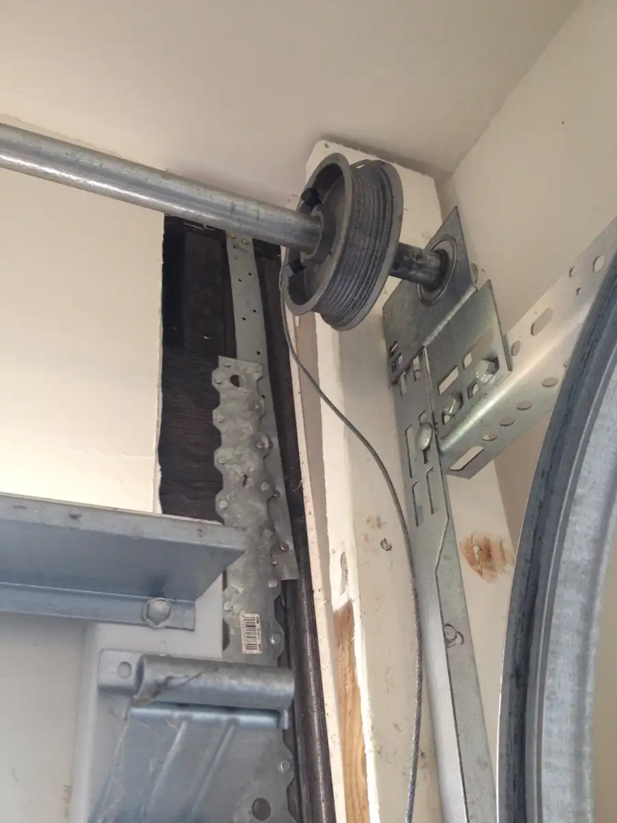 Loose cable on a cable drum above a garage door