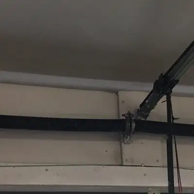 Torsion spring on a door header