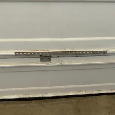 Door panel reinforcement strap