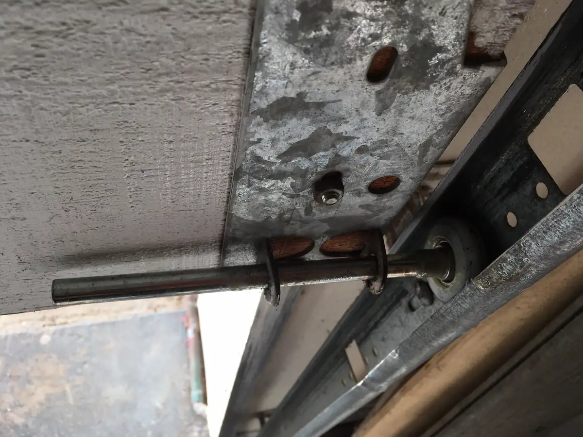 Garage door roller and stem in the track, seen from below